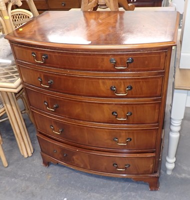 Lot 2527 - A bow fronted chest of five drawers, on...