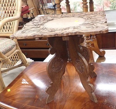 Lot 2528 - An Eastern carved table, 40cm high.