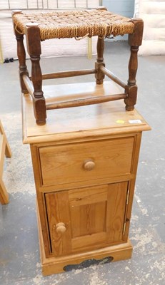 Lot 2549 - A pine bedside cabinet, the moulded top above...