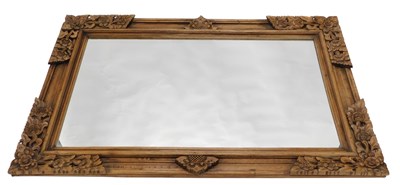 Lot 1545 - An Oriental hardwood wall mirror, carved with...