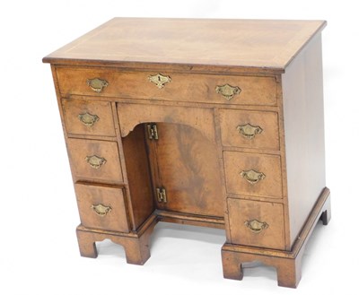 Lot 1551 - A walnut kneehole desk or dressing table, in...