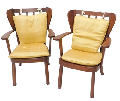 Lot 1569 - A pair of teak open armchairs, each with a...