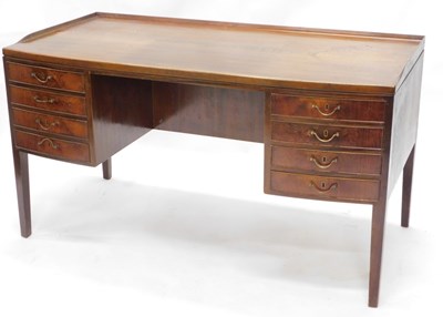 Lot 1573 - A Danish walnut kneehole desk, with a raised...