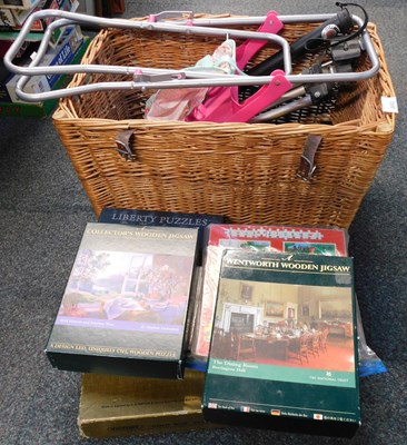 Lot 2053 - A wicker basket containing camera tripods, a...