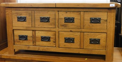 Lot 1006 - A light oak cabinet, with a sliding top...