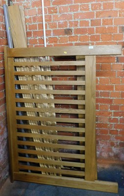 Lot 1012 - A light oak double bed, with side rails and...