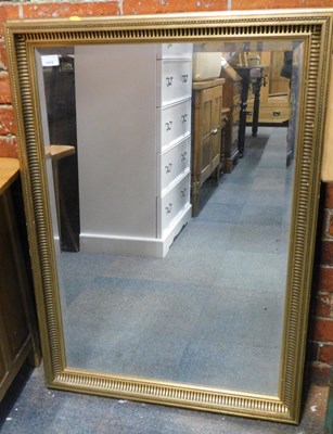 Lot 1019 - A gilt framed bevelled mirror, 90cm high, 60cm...