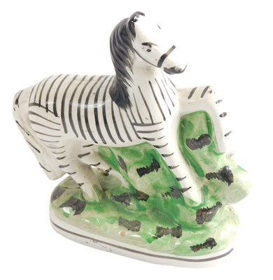 Lot 800 - A Staffordshire pottery model of a zebra, 16cm...