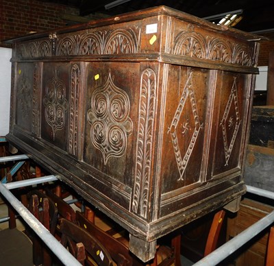 Lot 1038 - An 18thC carved oak coffer, with lift lid,...