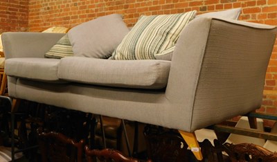 Lot 1050 - A blue upholstered two seater sofa.