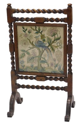 Lot 851 - A late 19thC/early 20thC oak fire screen, with...