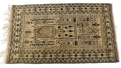 Lot 861 - An Eastern prayer rug, with a geometric design,...
