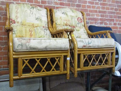 Lot 1027 - Two bamboo conservatory chairs, upholstered....