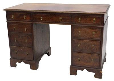 Lot 878 - A mahogany kneehole desk, the rectangular top...