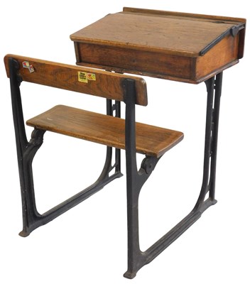Lot 34 - A 20thC oak school desk, with ink recess, a...