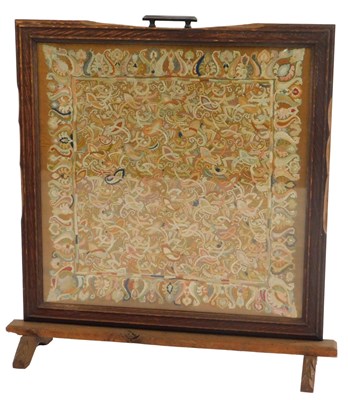 Lot 562 - An early 20thC oak framed fire screen, inset...