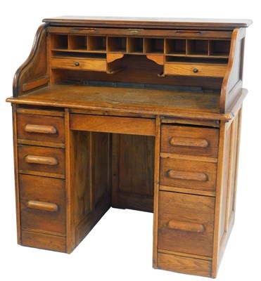 Lot 563 - A 1920s oak roll top desk, the tambour front...
