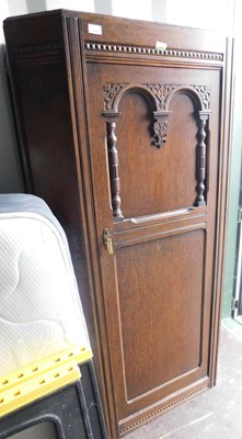 Lot 1092 - An oak hall cupboard, with carved overall...