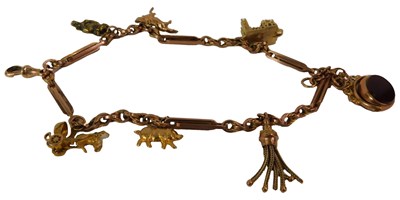 Lot 628 - A 9ct rose gold Albert chain, with five charms...