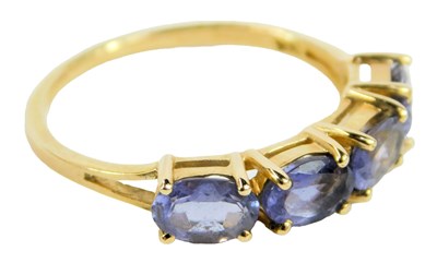 Lot 648 - A 14ct gold and tanzanite four stone ring,...