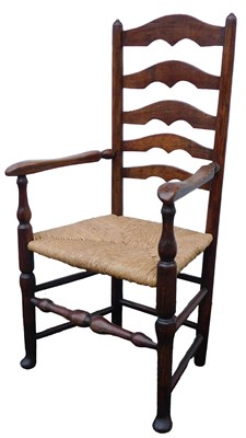 Lot 569 - A ladderback open armchair, with rush seat.