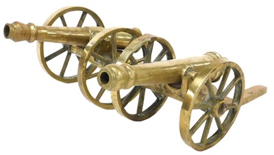 Lot 56 - A pair of brass table cannons, 52cm wide.
