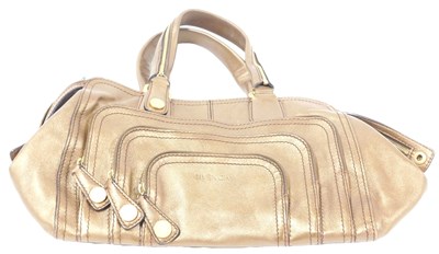 Lot 77 - A Givenchy gold leather hobo bag, of four...