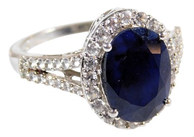 Lot 219 - A sapphire and CZ ring, the oval cut sapphire...