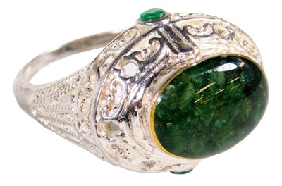 Lot 221 - A cabochon jade and CZ ring, in an oval mount,...