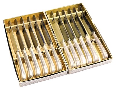 Lot 51 - A set of twelve George V silver pistol handle...
