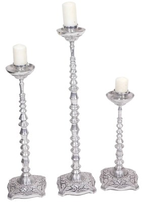 Lot 134 - A metal candleholder of turned form, raised on...