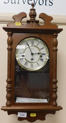 Lot 2120 - A Hermle oak cased wall clock, Roman numeric...
