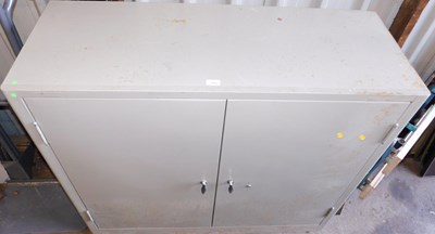 Lot 1058 - A Triumph grey metal two door office cabinet,...