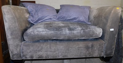 Lot 1071 - A grey upholstered cuddle chair.