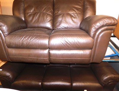 Lot 1103 - A brown leather three seater manual reclining...