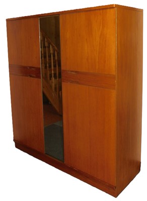 Lot 512 - A Uniflex teak triple wardrobe, with a central...