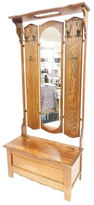 Lot 516 - An oak hall stand, with a shelf top, above a...
