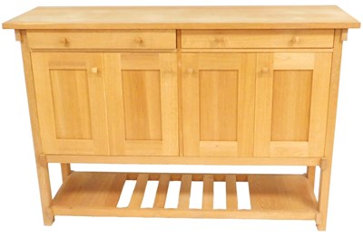 Lot 517 - A light oak dresser, with two drawers over...