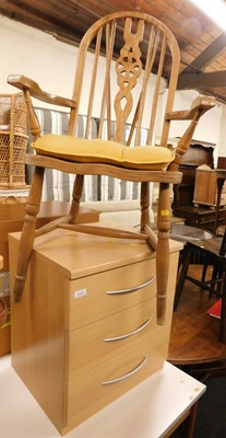 Lot 1136 - A three drawer chest, and a wheel back armchair.
