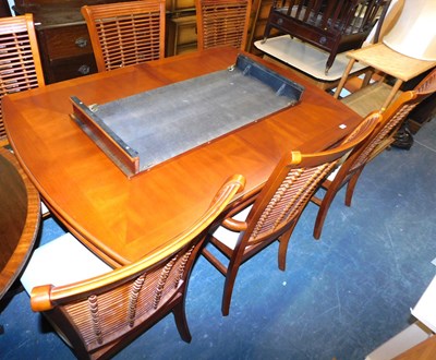 Lot 1130 - A hardwood extending dining table, on a...