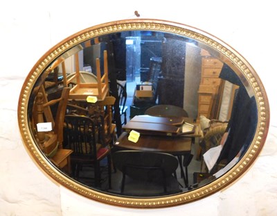 Lot 1144 - An oval gilt framed wall mirror, 62cm x 48cm.