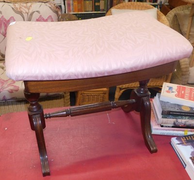 Lot 1182 - A footstool with a curved upholstered top, on...