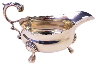 Lot 412 - A George V silver sauce boat, with a gadrooned...