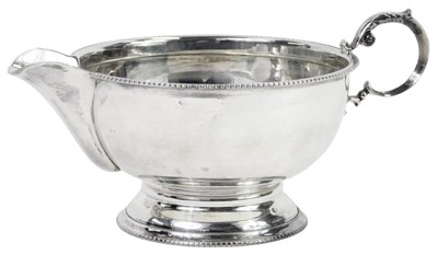 Lot 62 - A George V silver cream jug, with a ribbed...