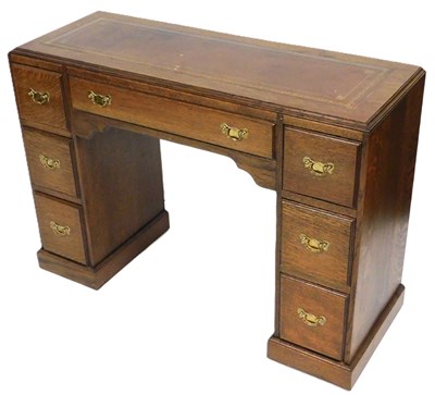 Lot 581 - An early 20thC oak twin pedestal desk, with a...