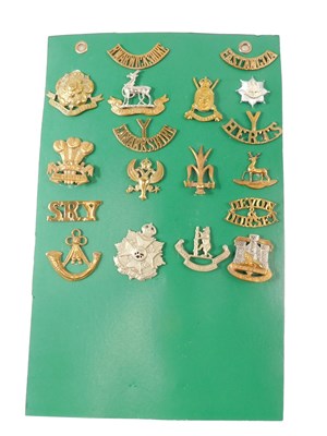 Lot 266 - A small collection of cap badges and shoulder...
