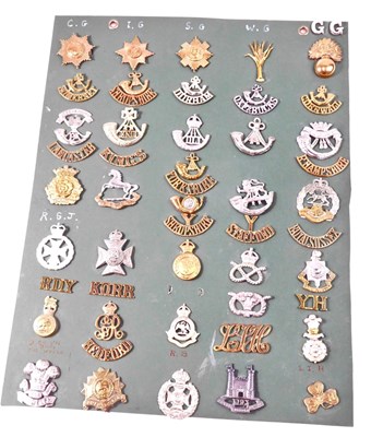 Lot 271 - A collection of cap badges and shoulder titles,...