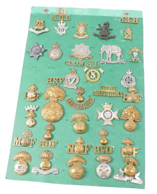 Lot 273 - A collection of cap badges and shoulder titles,...