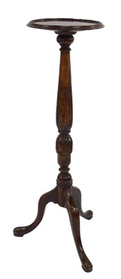 Lot 471 - A walnut torchere, the circular dished top on...