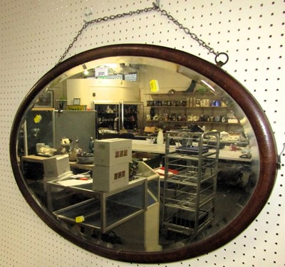 Lot 2121 - An oval bevelled wall mirror, 52cm high, 77cm...